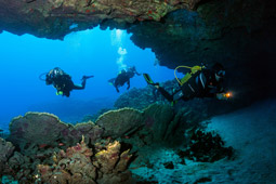 Scuba diving in underwater cave with flashlight.jpg